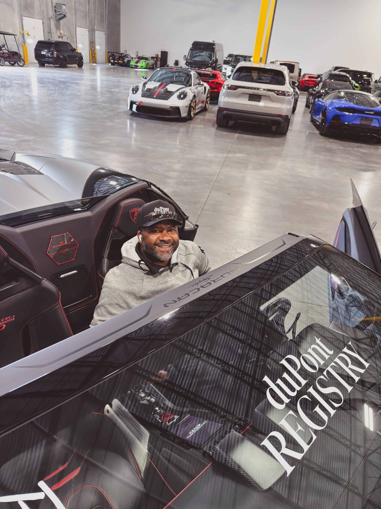 Gavin Brooks seated in a Lamborghini Huracán Spyder on the duPont REGISTRY floor