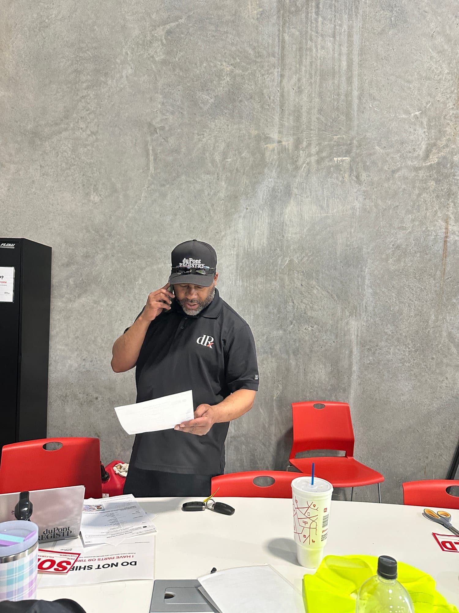 Gavin Brooks managing paperwork and calls on the operations floor